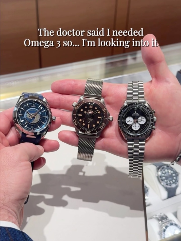 Three OMEGA watches held in hand